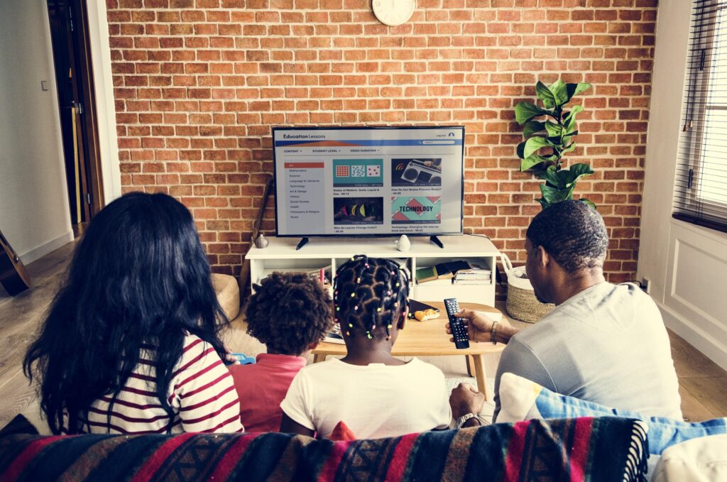 African family watching television together