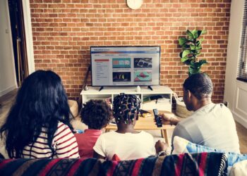 African family watching television together