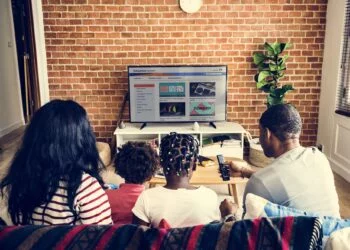 African family watching television together