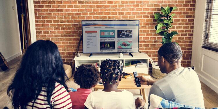 African family watching television together