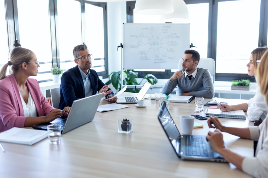 Business people discussing together in conference room during meeting at office.