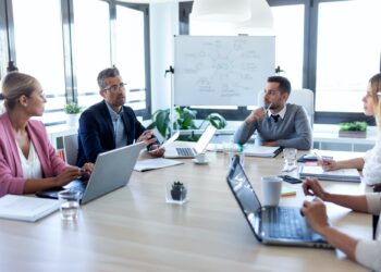 Business people discussing together in conference room during meeting at office.