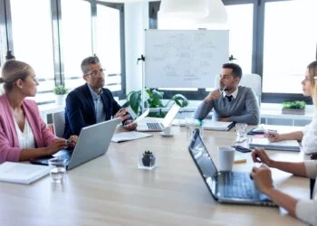 Business people discussing together in conference room during meeting at office.