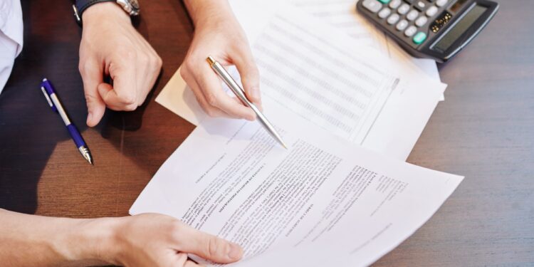 Businessmen checking partnership agreement