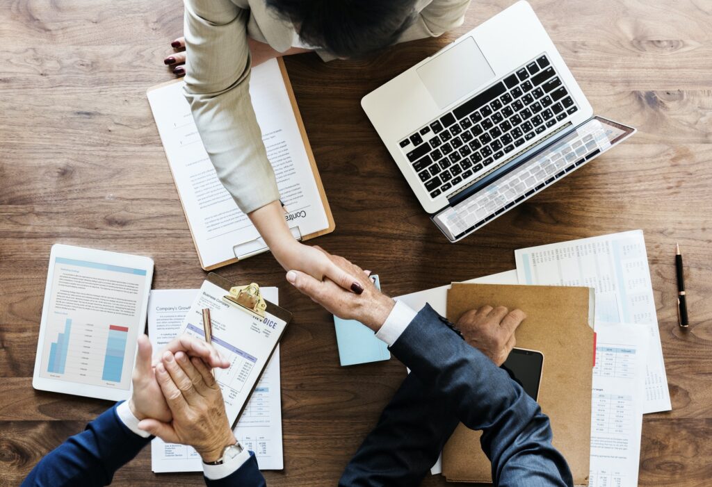 Businesspeople shaking hands together