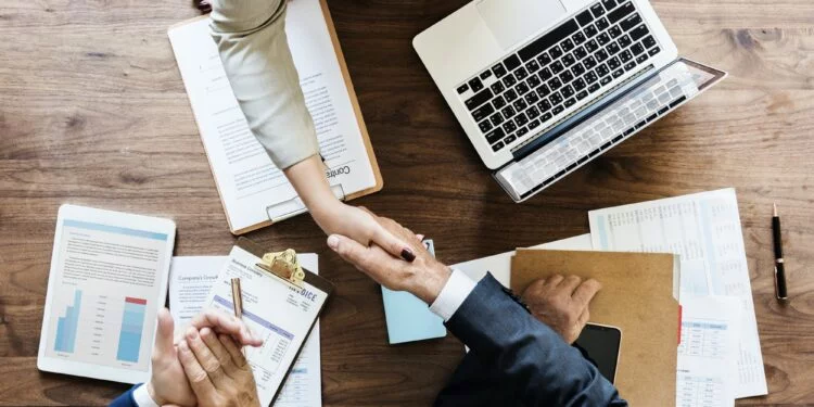 Businesspeople shaking hands together