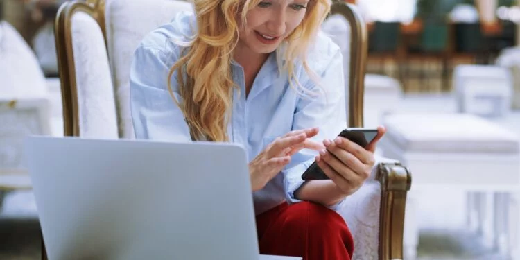 Businesswoman Using Smartphone in the Modern Bank Lobby