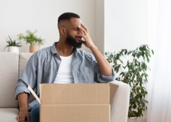 Disappointment in online shopping concept. Guy presses hand to face