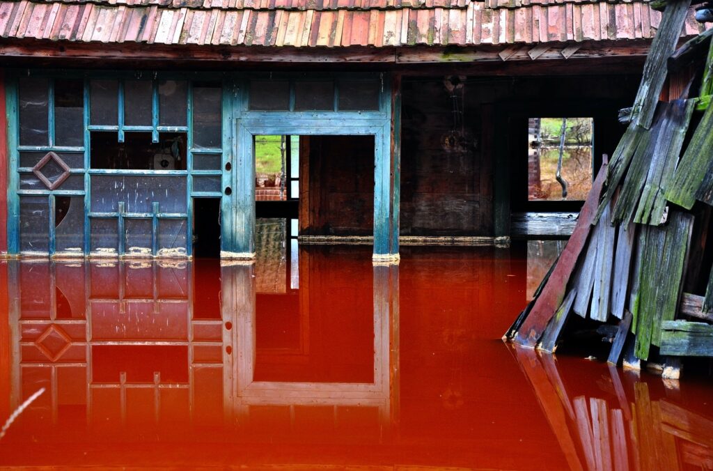 Ecological disaster. House flooded by contaminated water from a copper mine. Rosia Montana, Romania