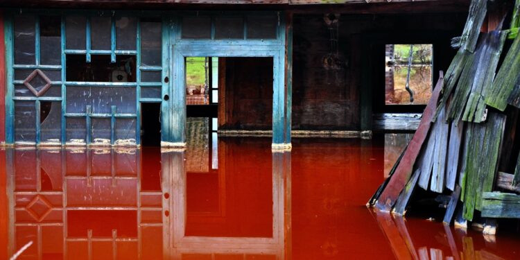 Ecological disaster. House flooded by contaminated water from a copper mine. Rosia Montana, Romania