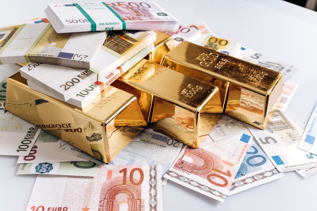 Gold bullions at euro banknotes closeup background. Gold bars lie on Euro banknotes