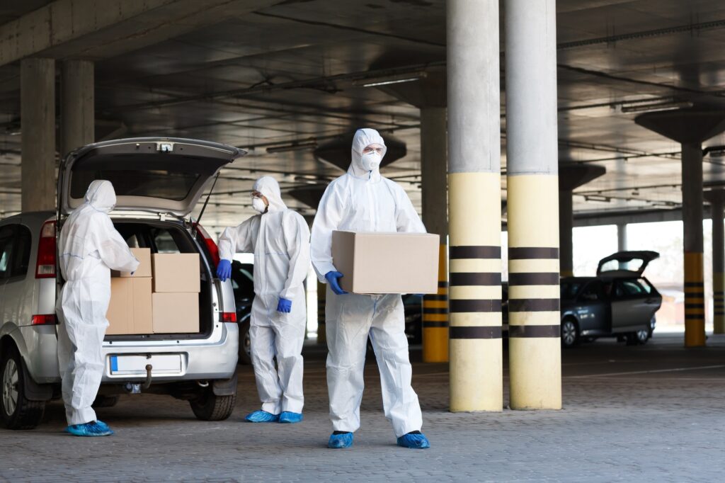 Medical workers delivering vaccine from coronavirus biohazard