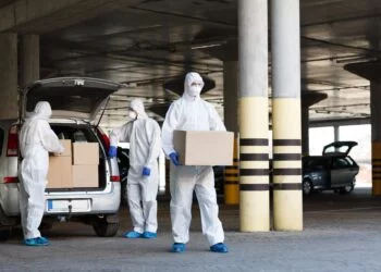 Medical workers delivering vaccine from coronavirus biohazard