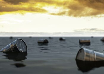 Oil barrels floating on the oil sea. Oil industry crisis concept.