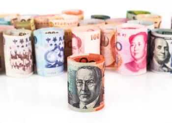 Pile of rolled-up currency notes with Australian Dollar in front