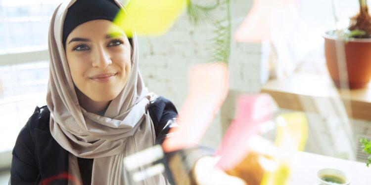 Portrait of a beautiful arabian businesswoman wearing hijab while working