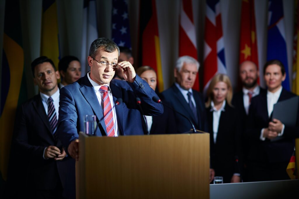 Spokesman adjusting glasses at summit