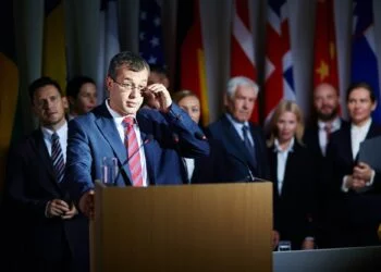 Spokesman adjusting glasses at summit