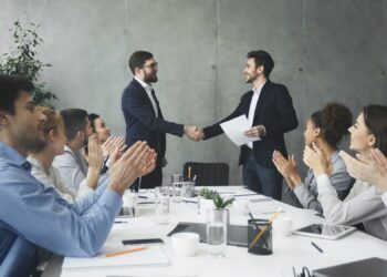 Striking grand deal. Business people congratulating their colleagues