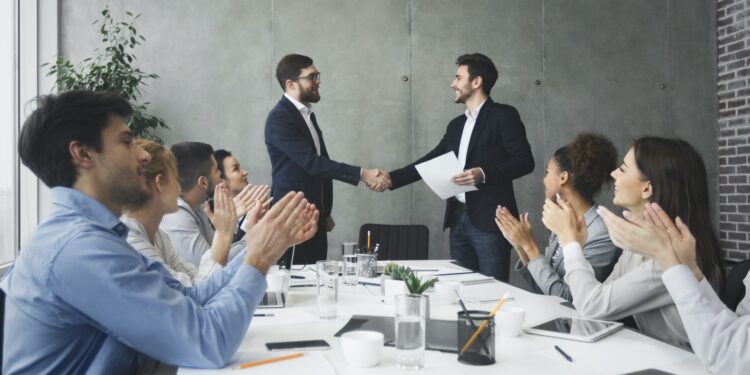 Striking grand deal. Business people congratulating their colleagues