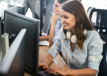 Successful happy woman working at office. Technology, computer, startup, business concept