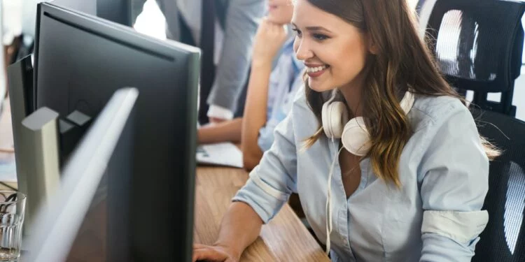 Successful happy woman working at office. Technology, computer, startup, business concept