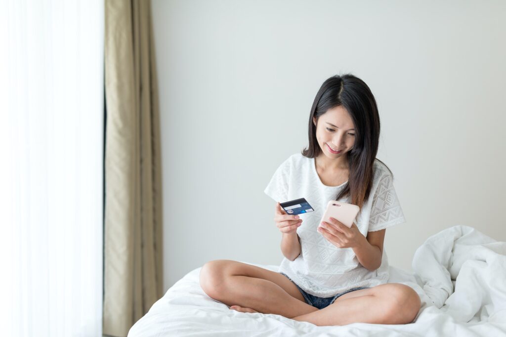 Woman use of mobile phone and credit to shopping online