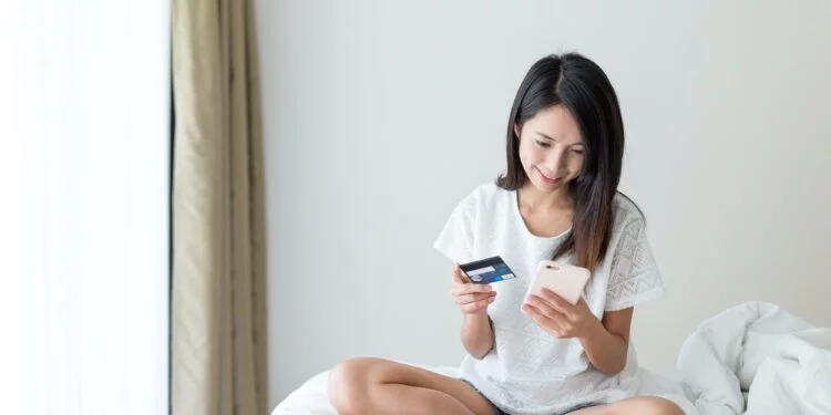 Woman use of mobile phone and credit to shopping online