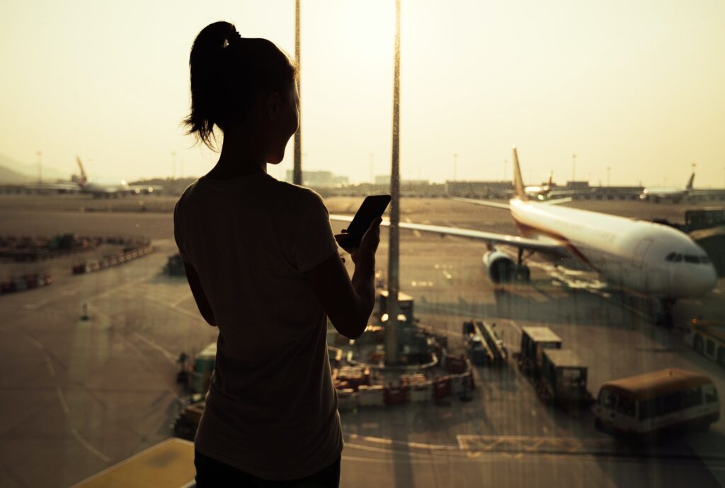 woman using cellphone in airport