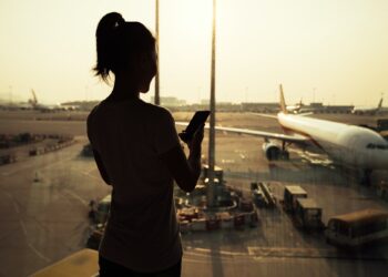 woman using cellphone in airport