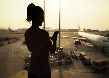 woman using cellphone in airport