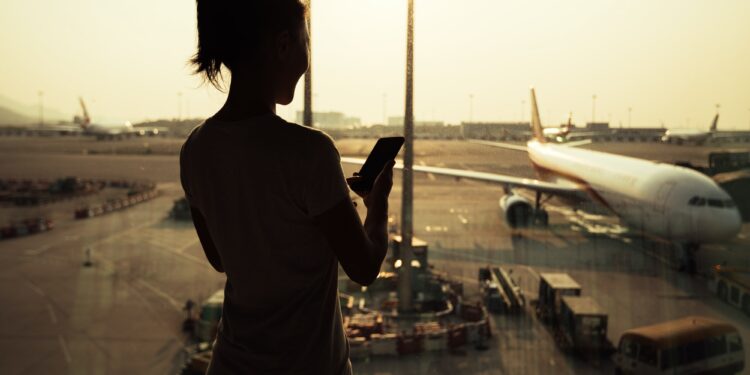 woman using cellphone in airport