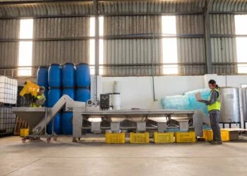 Workers working together near production line