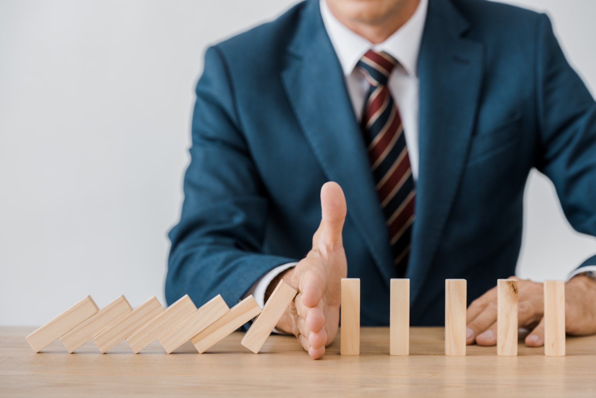 close up of businessman with blocks wood game in office, insurance concept