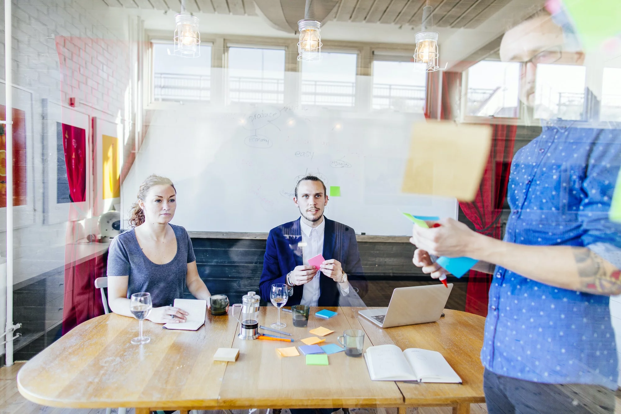 Team of creative business people preparing presentation in board room