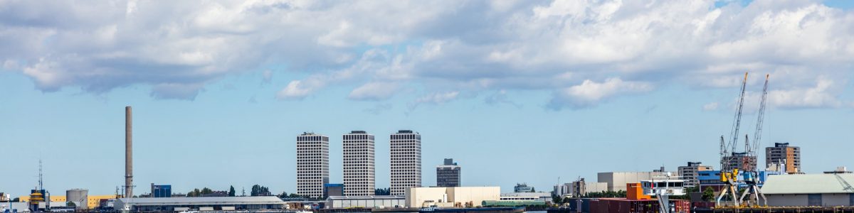 Container ship and logistics against Rotterdam cityscape