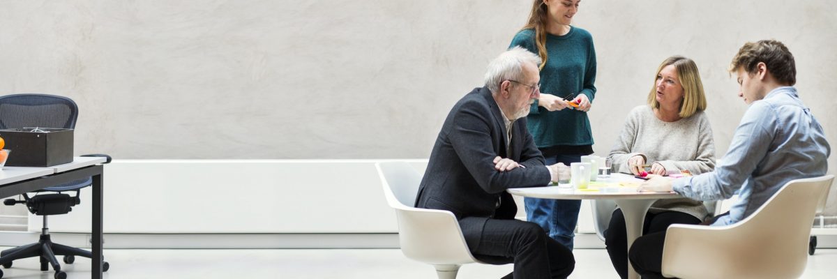 Team of business people having discussion at table in creative office